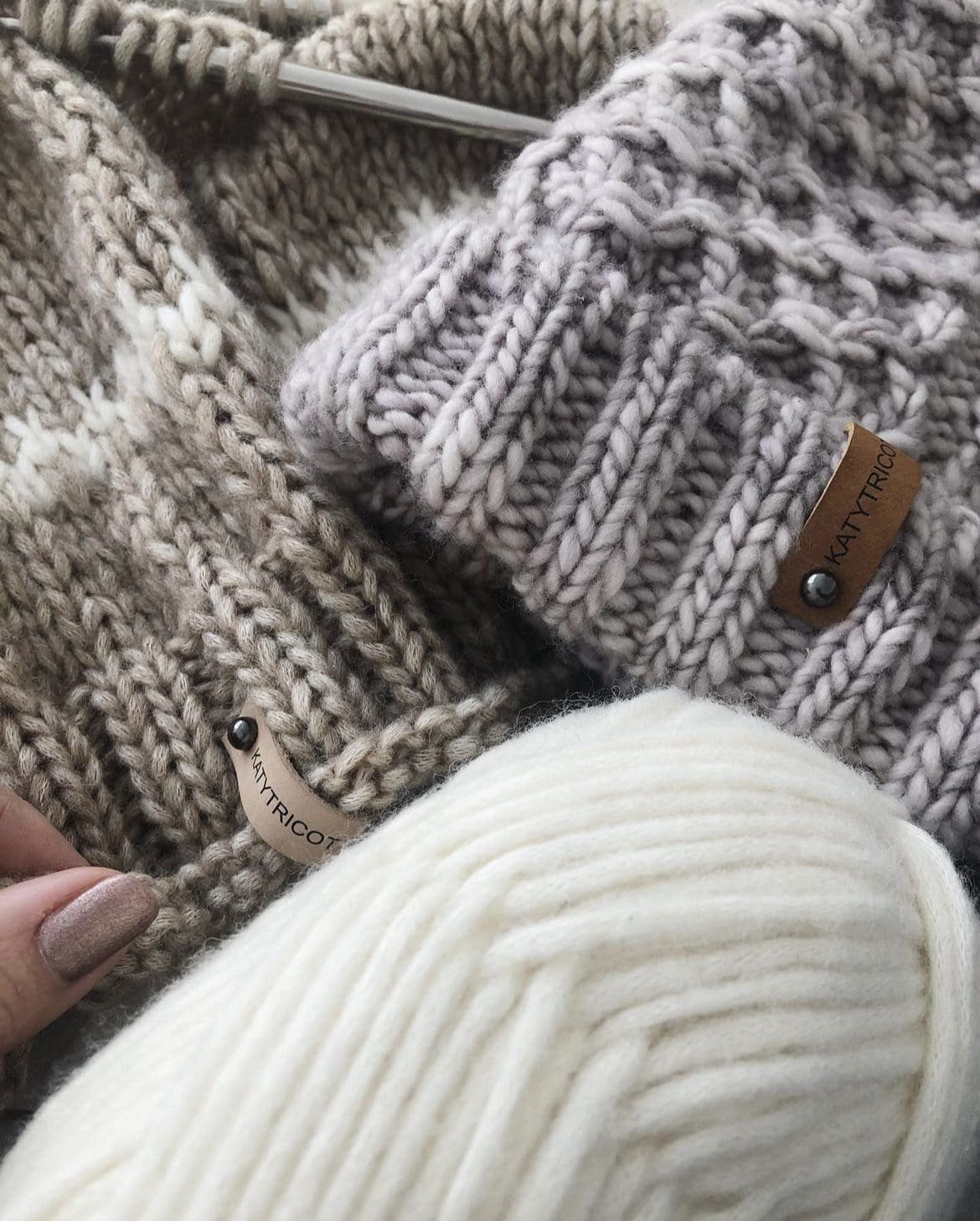 Close-up of knitted 2x2 rib hats with yarn. Cable cast-on knit tip.