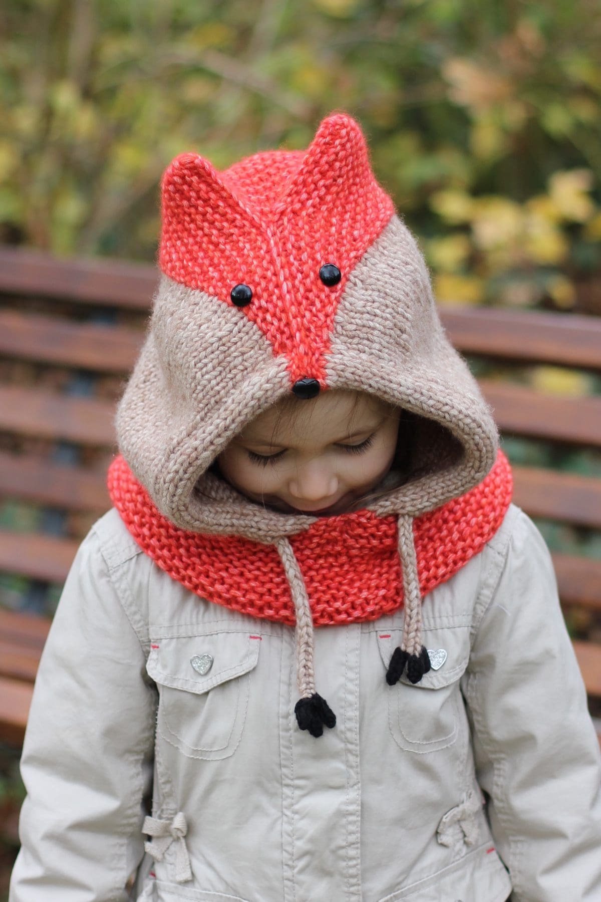 Child wearing a fox knit hat. Cute winter fashion for kids, handmade knitted headwear.