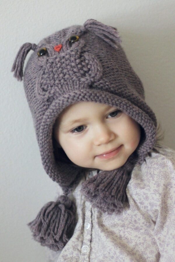 Cute baby girl wearing a knitted hat. Winter fashion for kids.