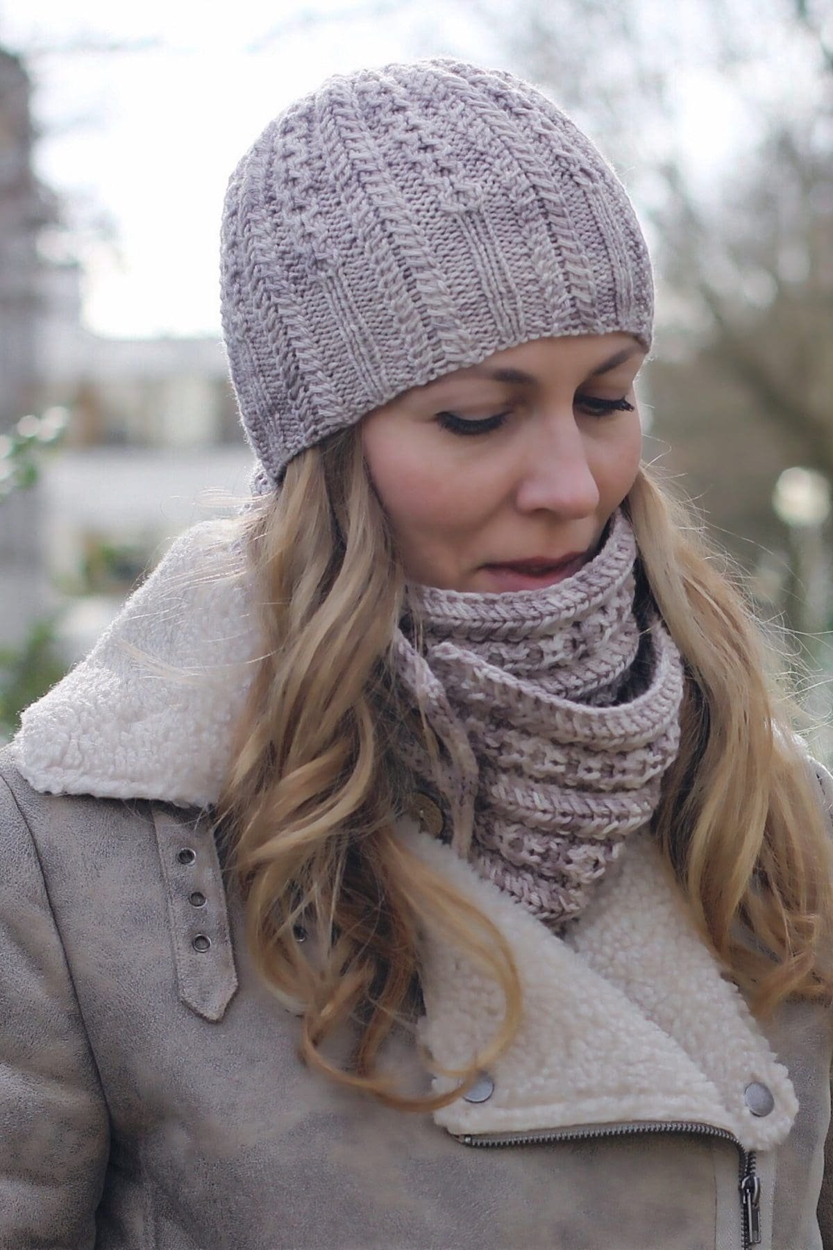 Woman in knit hat and scarf. Winter fashion. Warm clothing.