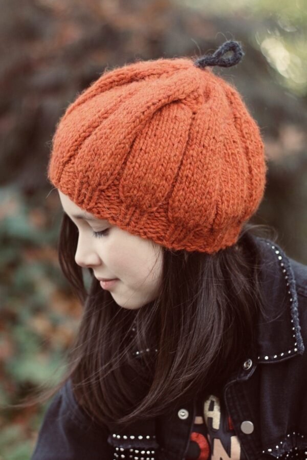Girl in orange knit hat. Fall fashion, cozy knitwear.