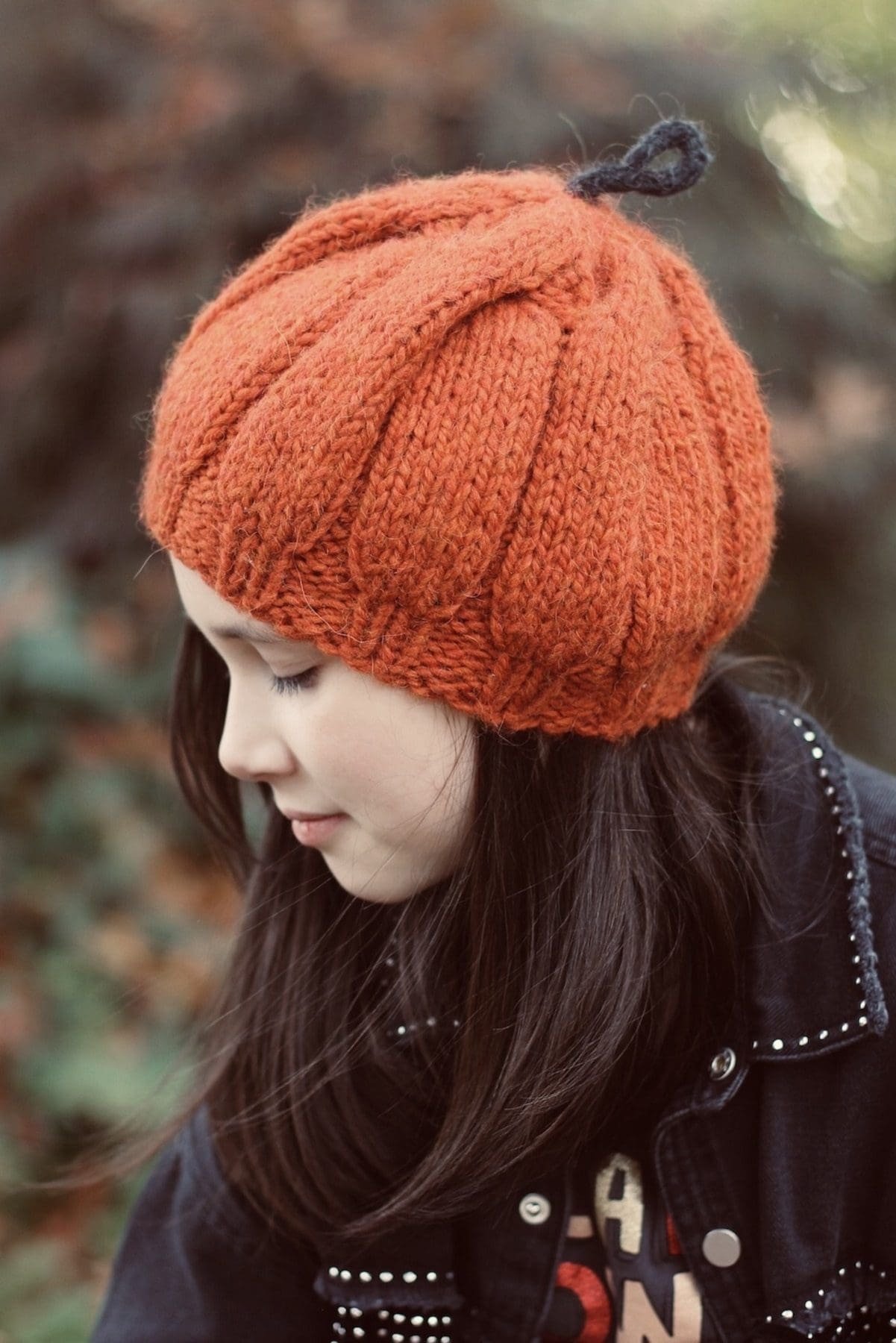 Girl in orange knit hat. Fall fashion, cozy knitwear.