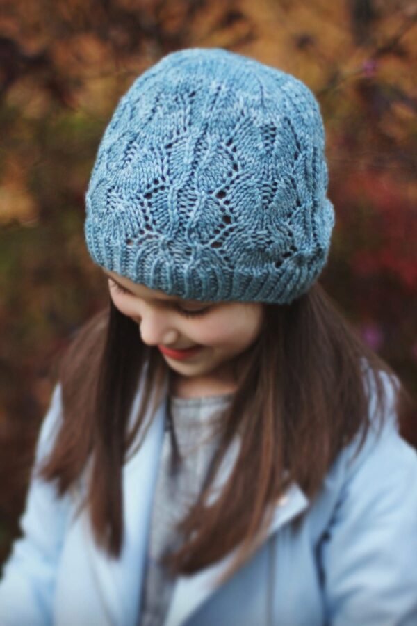 Girl in blue knit hat. Winter fashion, cozy style.