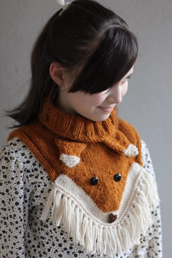 Woman wearing a fox knit cowl. Handmade knitwear fashion accessory.