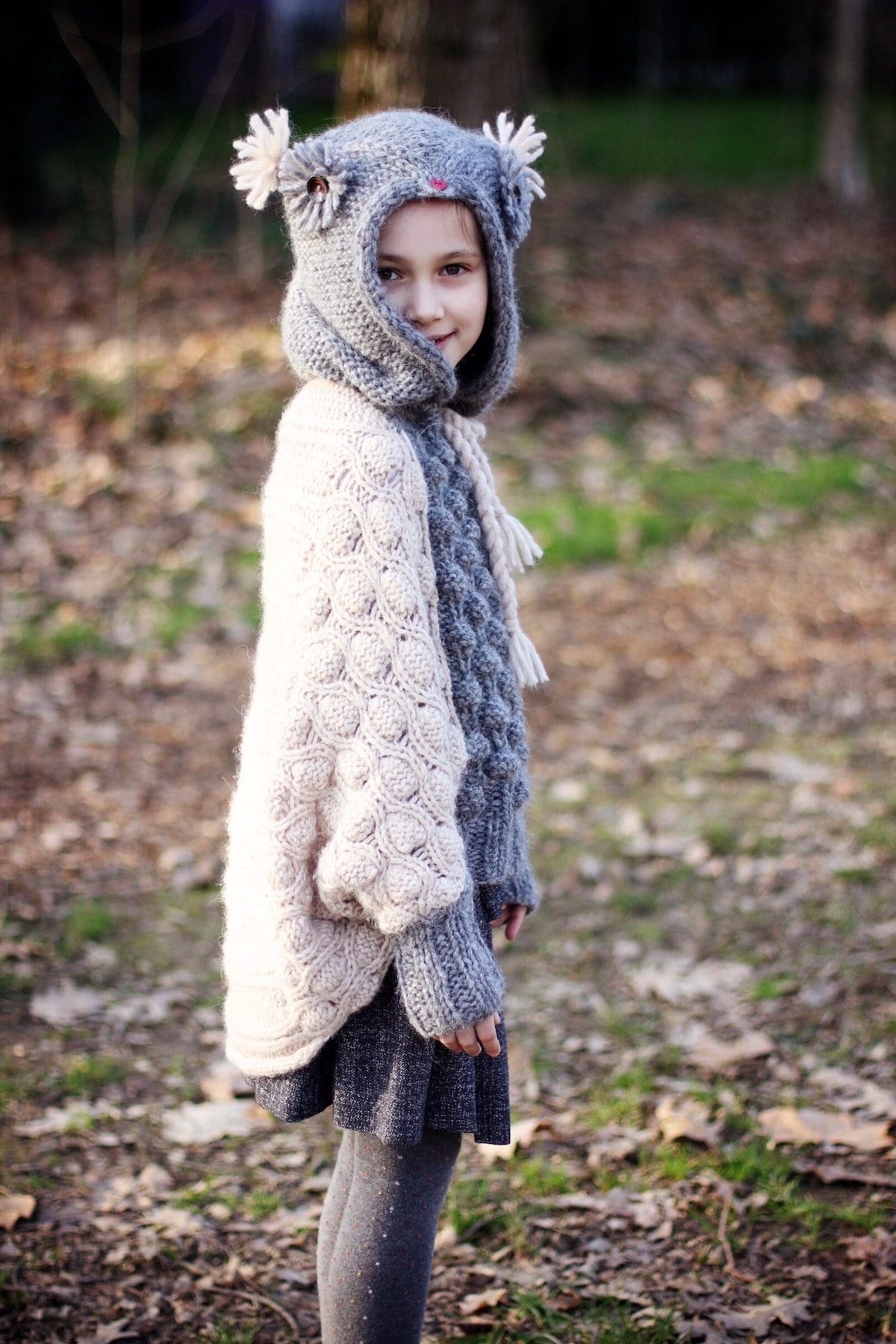 Close-up of knitted wool sweater and scarf. Cozy winter fashion. Warm knitwear.