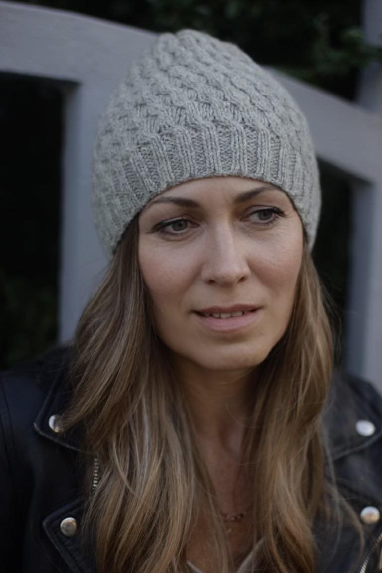 Woman wearing a Soft Swell Beanie. Stylish knit beanie for women. Winter hat fashion.