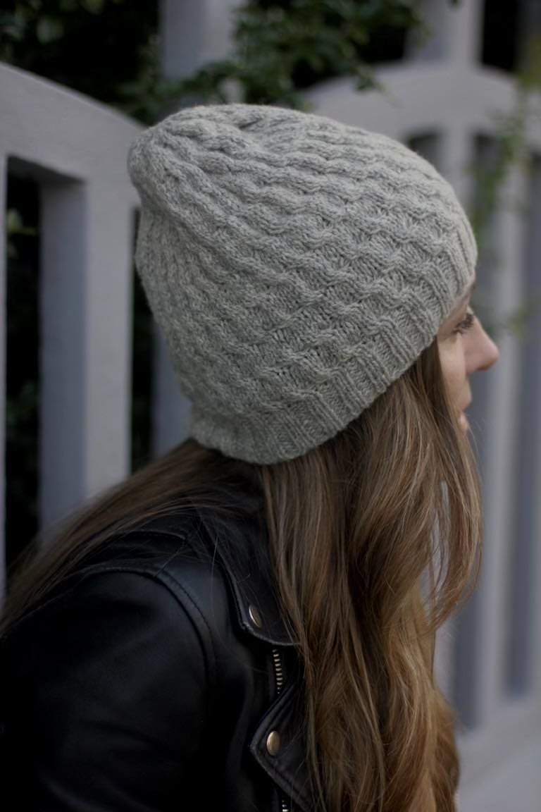 Woman wearing a soft swell beanie. Knit hat for winter warmth and style.