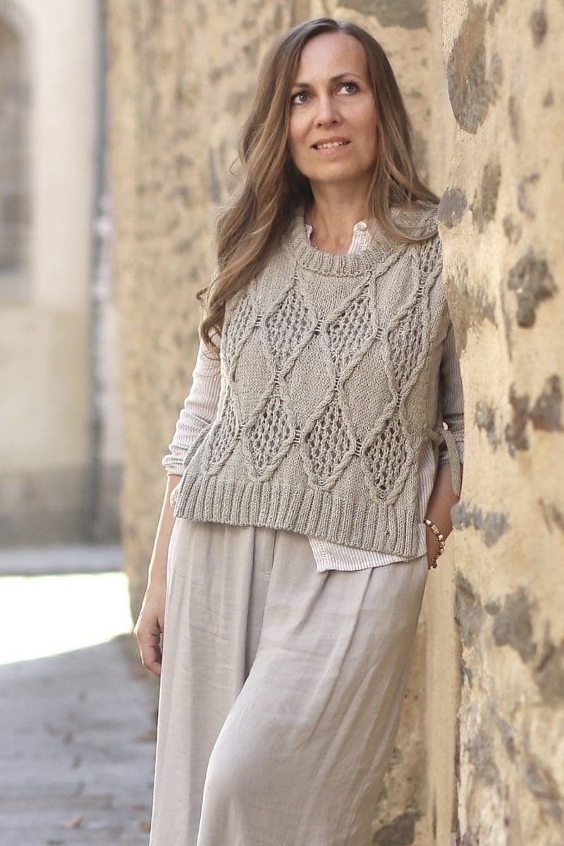 Woman wearing Diamonds Vest. Knitted vest with diamond pattern. Fashionable knitwear.