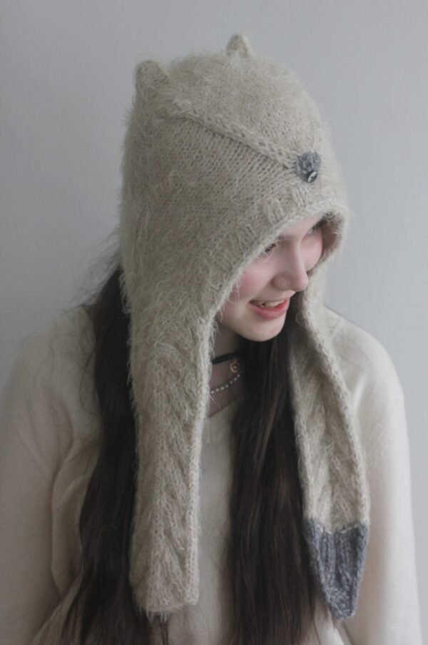 Smiling woman wearing a Tippy Ears Hat. Cozy, knit winter hat with ear flaps.