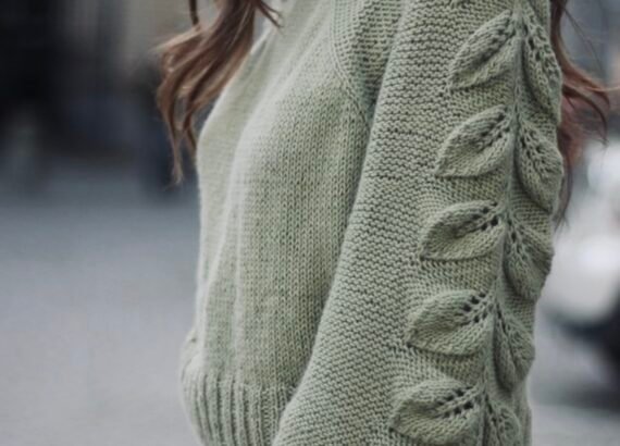Seamless top-down raglan sweater knitting pattern with leaf motif sleeves.