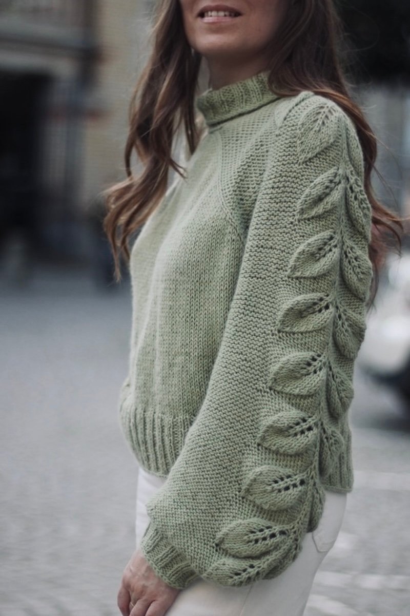 Seamless top-down raglan sweater knitting pattern with leaf motif sleeves.