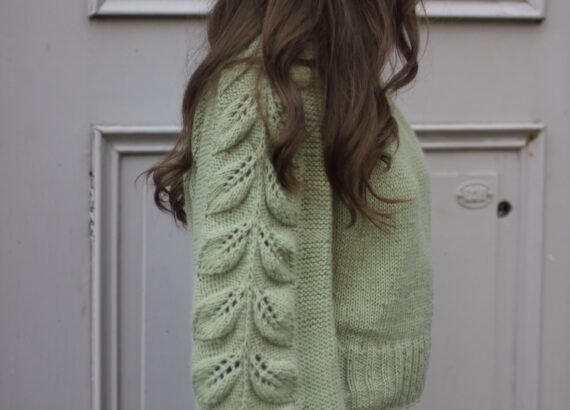Top-down raglan sweater knitting pattern with botanical leaf motif sleeves.